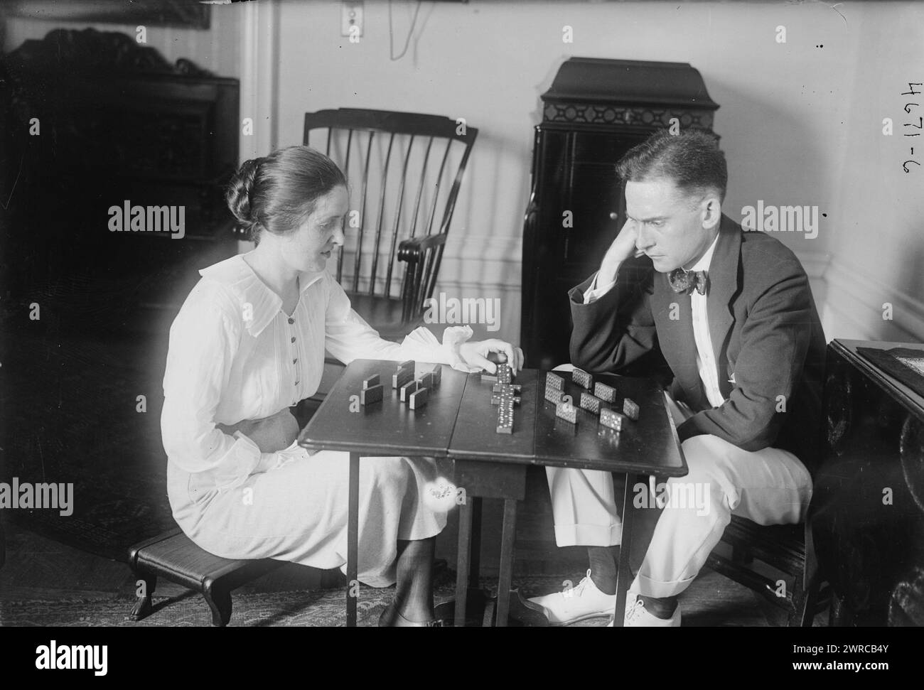 Elliott Shaw & wife, Photograph shows singer Elliott Shaw (1887-1973) with wife Abigail Schaulf Shaw (1889-1972) playing dominoes., between ca. 1915 and ca. 1920, Glass negatives, 1 negative: glass Stock Photo