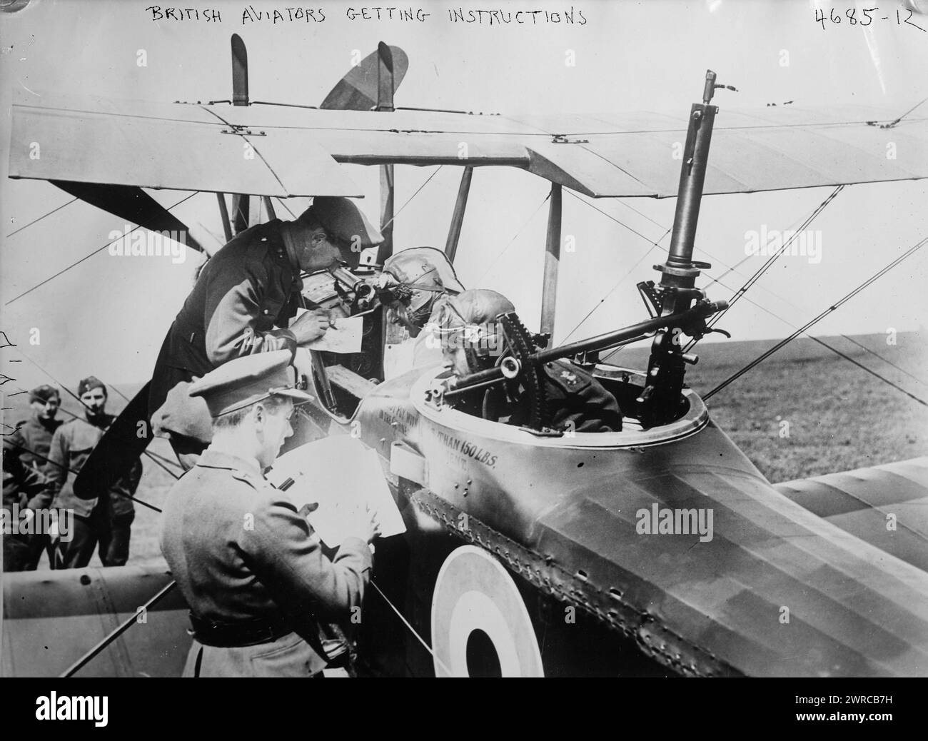 British aviators getting instructions, Photograph shows the the pilot and observer of a Royal Aircraft Factory R.E.8 biplane (serial number B5106) of No. 59 Squadron receiving instructions from Major Charles Jospeh Mackay before taking off from the Vert-Galland Aerodrome, France, May 15, 1918. The observer's Lewis gun is on a Scarff ring., 1918 May 15, World War, 1914-1918, Glass negatives, 1 negative: glass Stock Photo