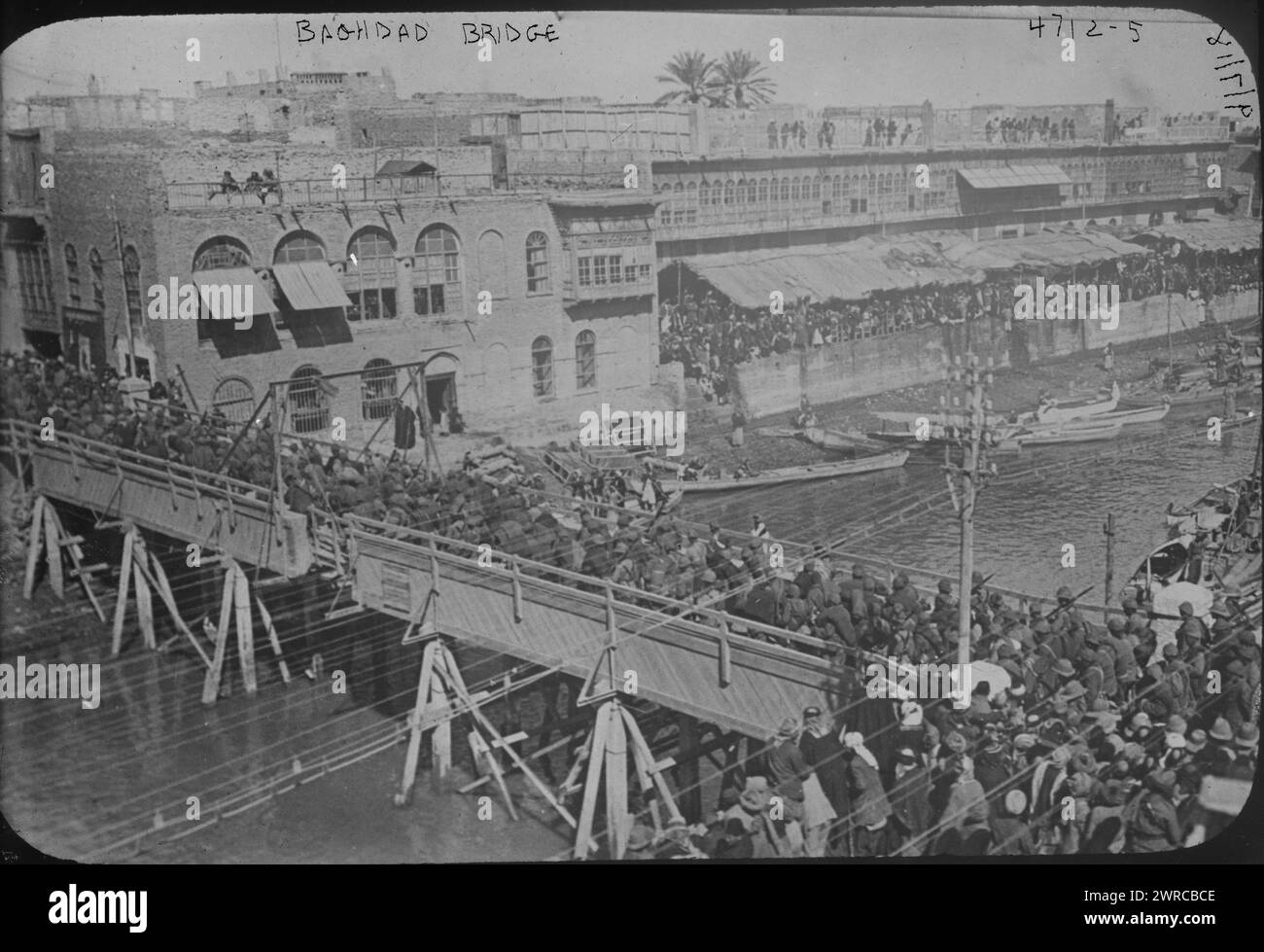 Bridge over Ashar Creek, Basra, Iraq, Photograph shows people, including soldiers, crossing a bridge over Ashar Creek in Basra, Iraq., 1918 Sept. 7, Glass negatives, 1 negative: glass Stock Photo