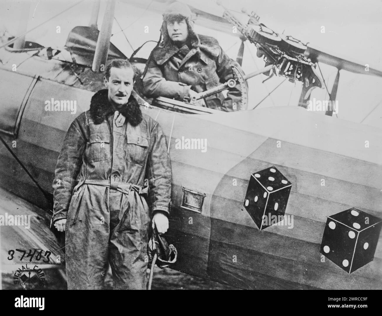 Capt. W.C. Schauffler Jr. & Lt. F.A. Tillman, Photograph shows Captain W.G. Schauffler, Jr. standing and Lieutenant Fred A. Tillman in the seat of a Ninetieth Aero Squadron (Pair-a-Dice' Squadron) airplane (Salmson 2A2). The gun on the airplane is a double Lewis machine gun. Photograph was taken in Bethelainville, Meuse, France on November 18, 1918 after World War I., 1918 Nov. 18, World War, 1914-1918, Glass negatives, 1 negative: glass Stock Photo