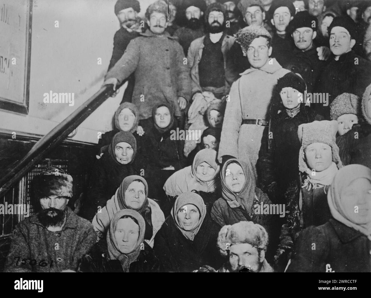 Refugees in R.R. station, Cheliabinsk, Photograph shows refugee men and women gathered at a train station at Chelyabinsk, Russia., between ca. 1915 and ca. 1920, Glass negatives, 1 negative: glass Stock Photo