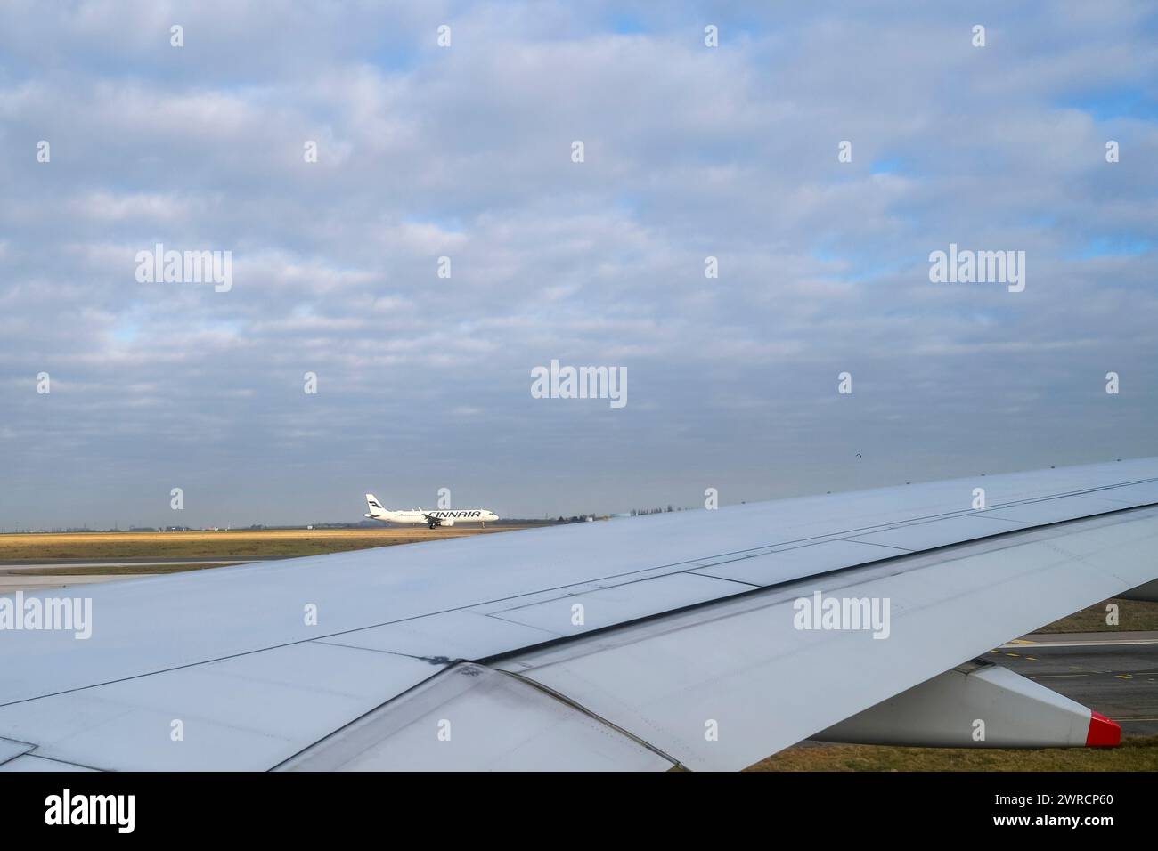 A Finnair airplane seen above the wing of another aeroplane Stock Photo