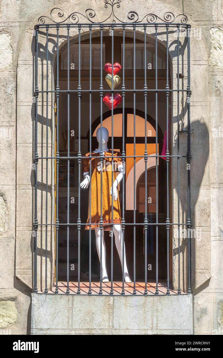Oaxaca, Mexico - A mannequin behind bars in a clothing store window. Stock Photo
