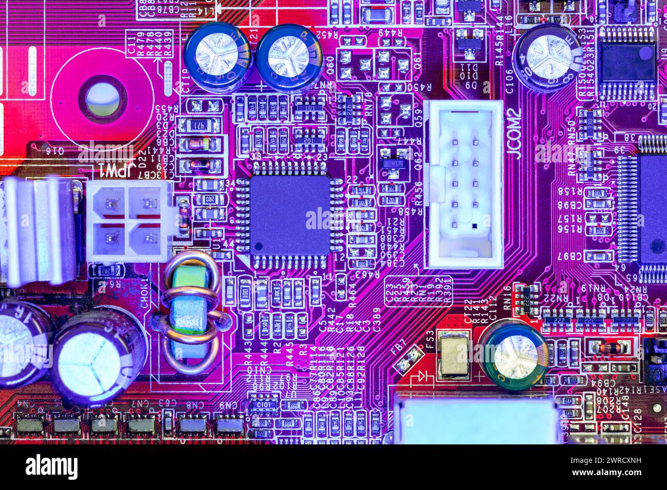 computer main board with sockets and chips. high-detailed view in blue red color. Stock Photo