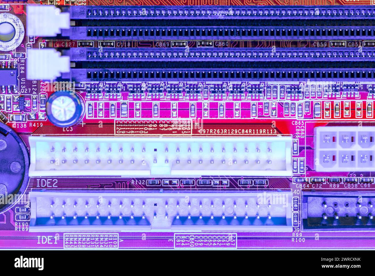 computer main board with sockets and chips. high-detailed view in blue red color. Stock Photo