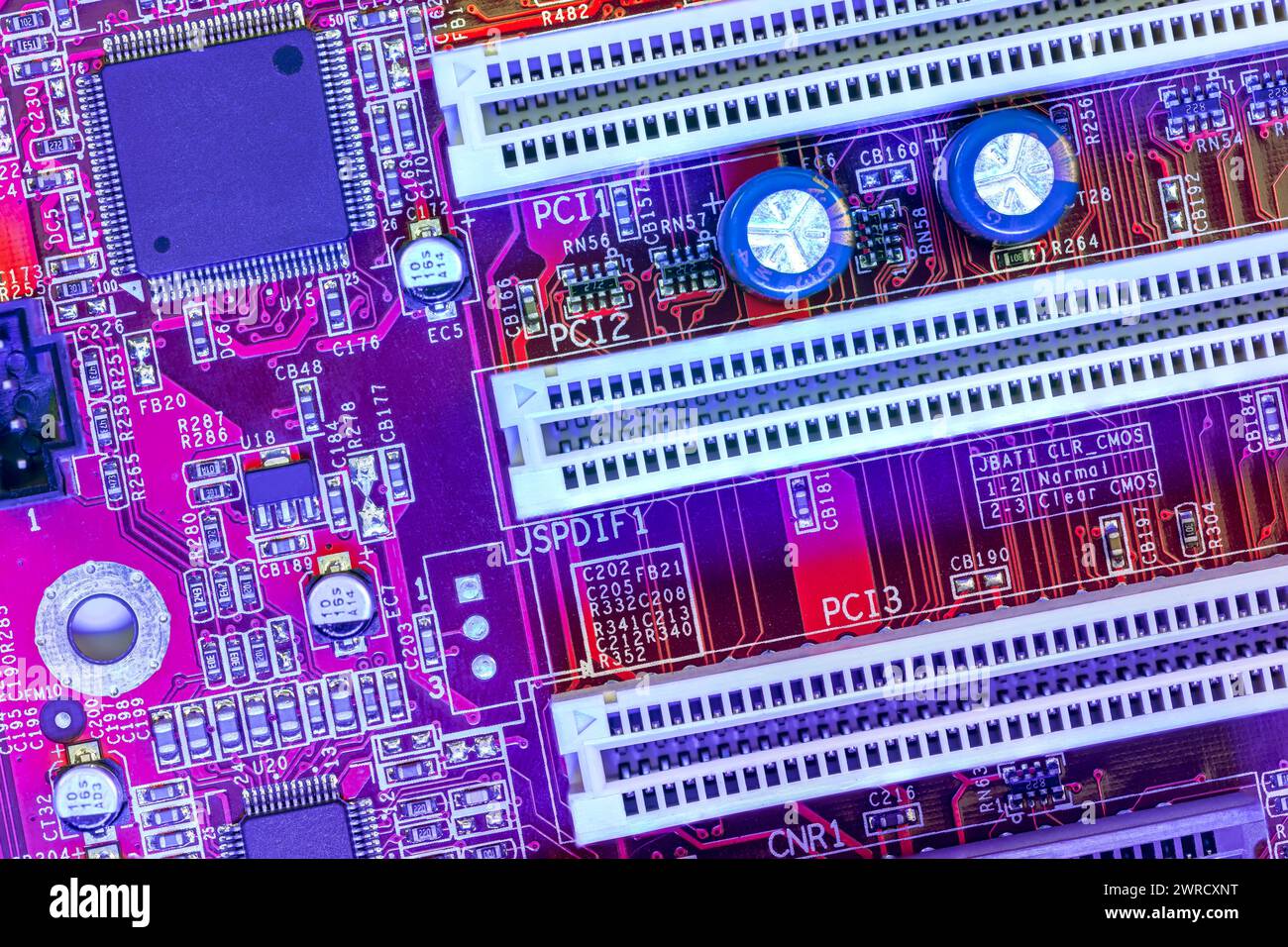 computer main board with sockets and chips. high-detailed view in blue red color. Stock Photo