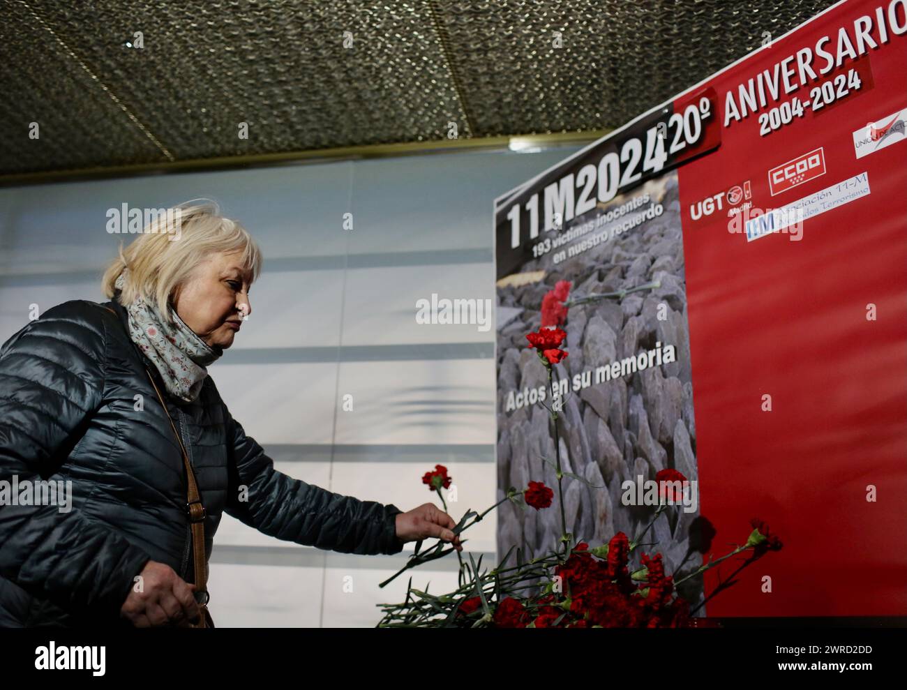 Madrid, Spain. 11th Mar, 2024. A woman places a flower in front of the memorial to the victims of the bomb attack at Atocha station. The Islamist train attacks in Madrid on the morning of March 11, 2004, which left more than 190 people dead and around 2000 injured, involved a series of simultaneous bomb attacks on a commuter train. Credit: Cesar Luis de Luca/dpa/Alamy Live News Stock Photo