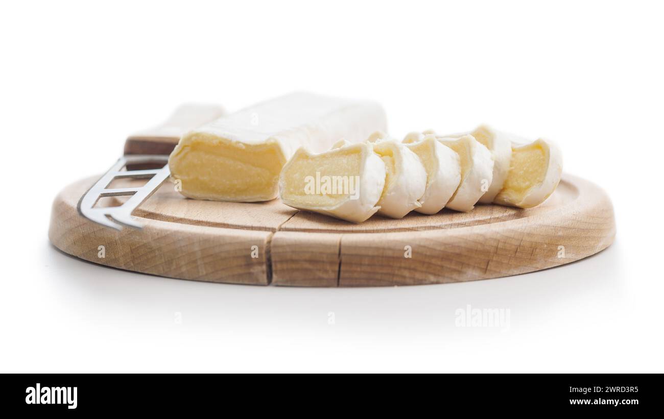 Tasty soft cheese elegantly presented on a wooden cutting board with slices ready to serve Stock Photo