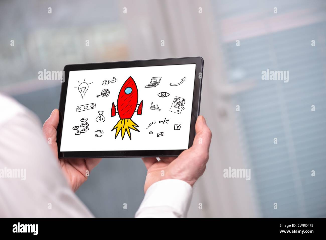 Start up concept shown on a tablet held by a man Stock Photo