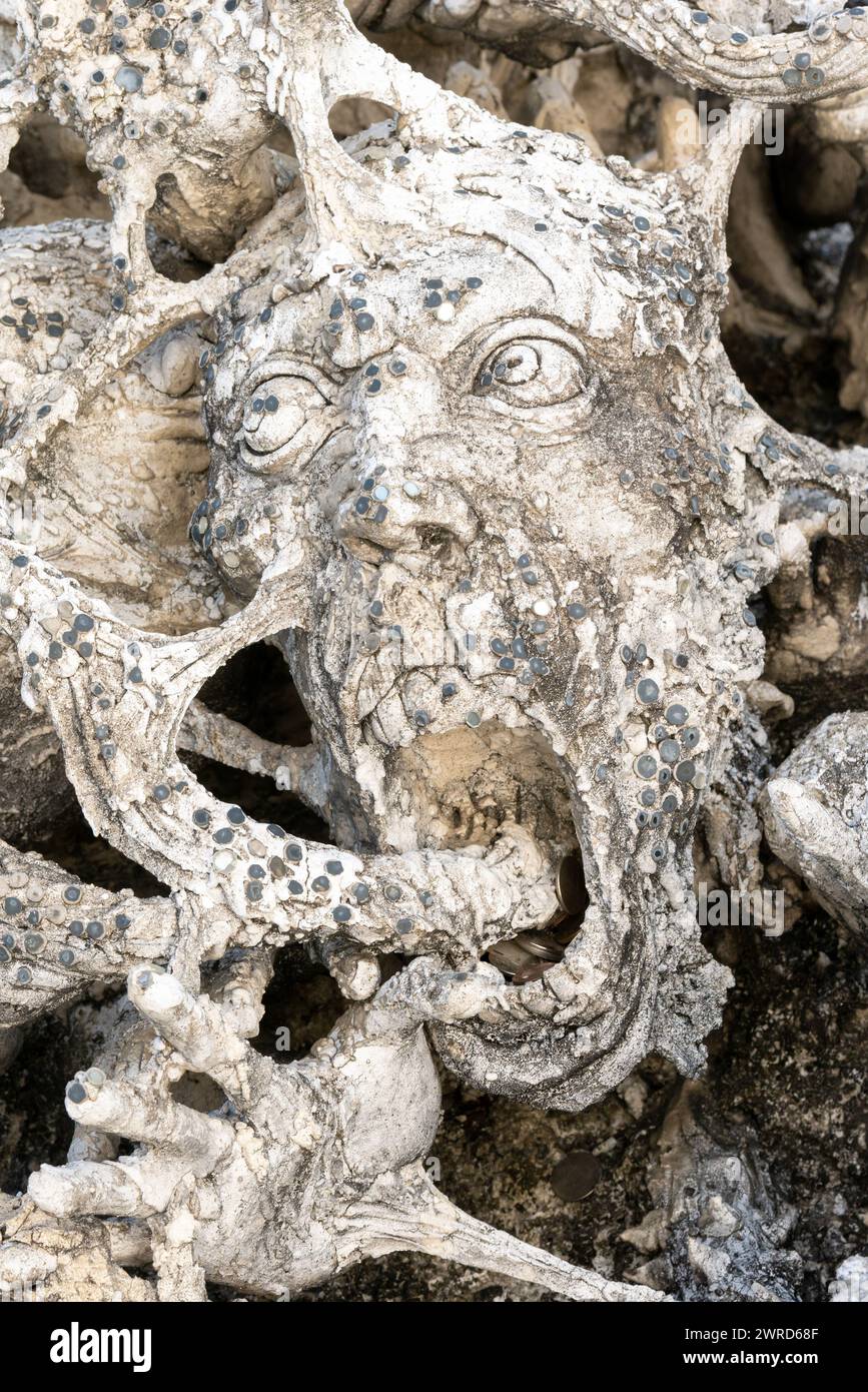 Chiang Rai, Thailand - December 2022: famous screaming heads sculls from hell art on the territory of White Temple Wat Rong Khun many statues Stock Photo