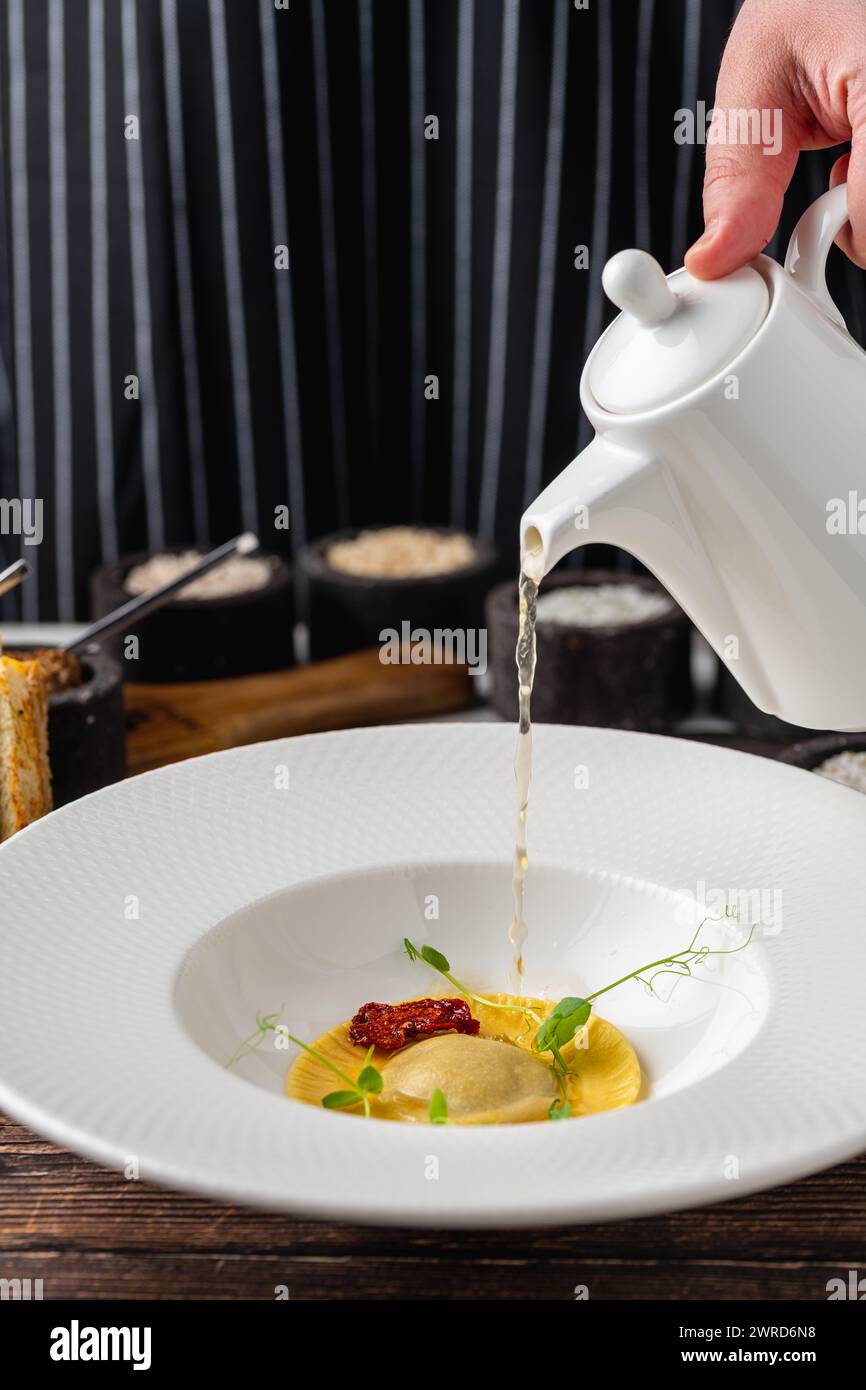 Ravioli consomme on a white porcelain plate. Healthy eating concept