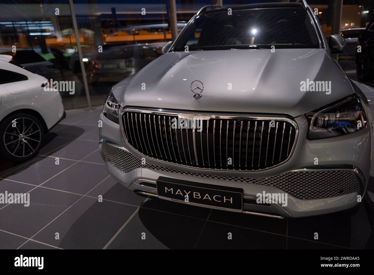 new electric silver Maybach GLS SUV, car in showroom, EV Mercedes-Benz Group, environmental cleanliness vehicle, Innovation in automotive industry sho Stock Photo