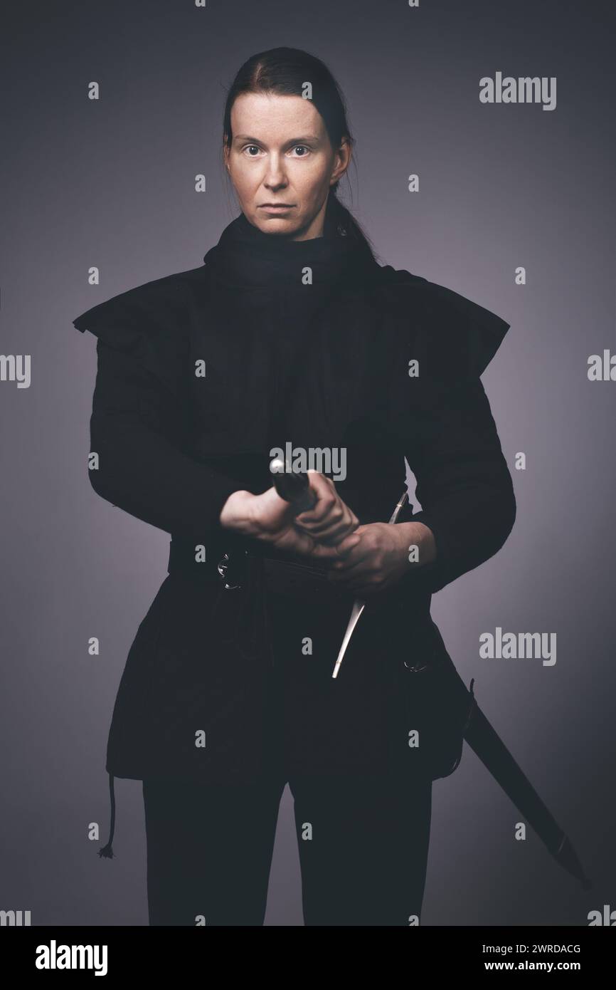 Medieval infantry armed woman dressed in classic gambeson Stock Photo