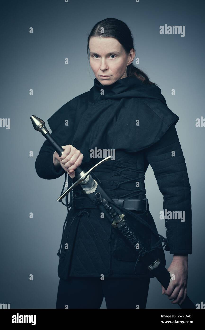 Medieval infantry armed woman dressed in classic gambeson Stock Photo