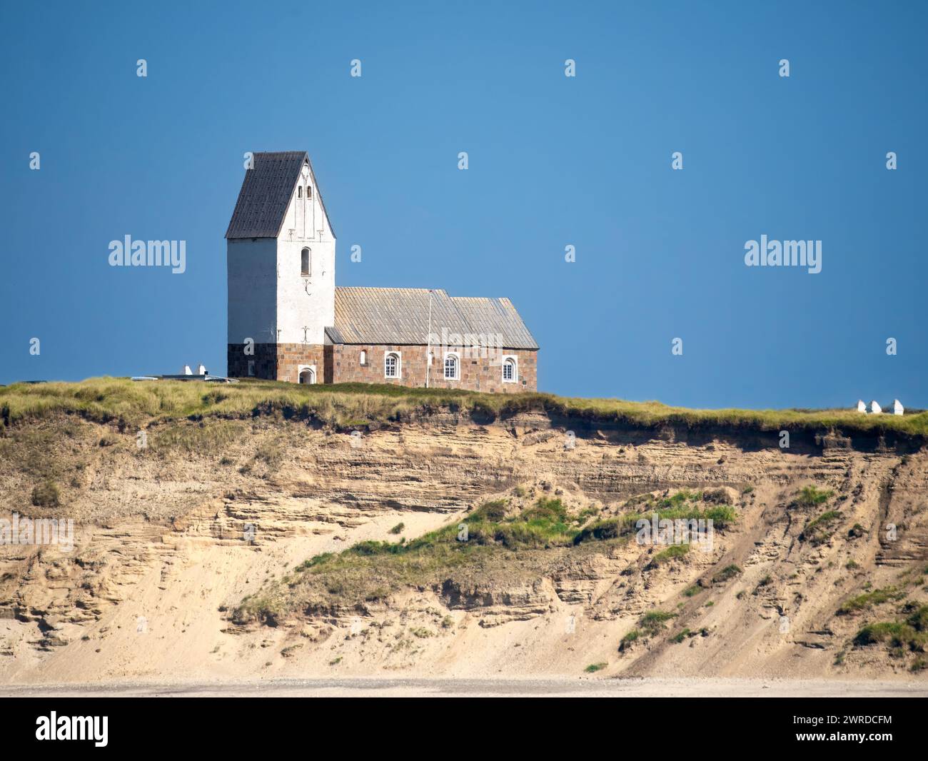 View of Church of Trans on cliff from North Sea, Ferring, Lemvig, Central Jutland, Denmark Stock Photo