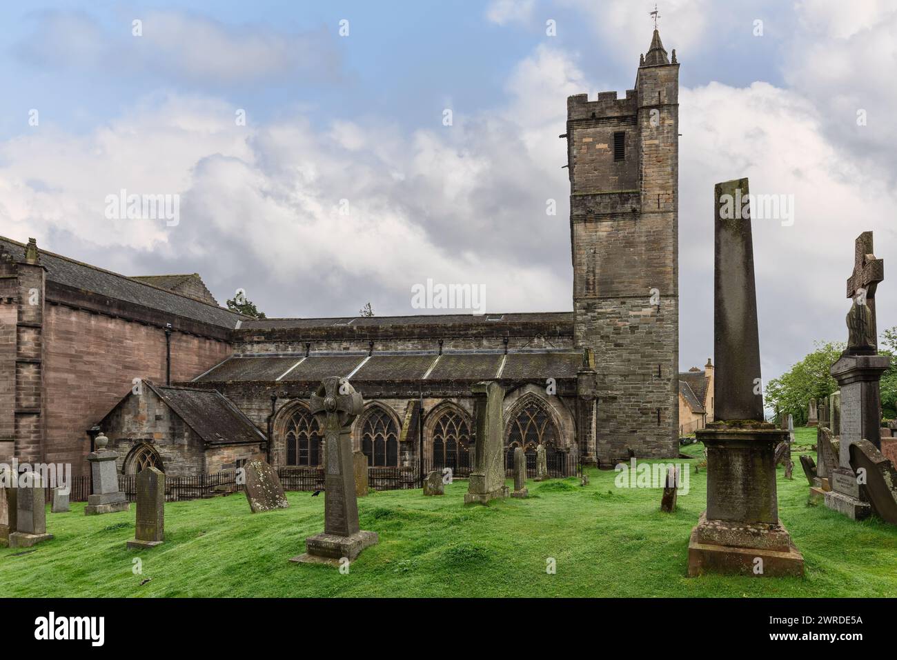 Amidst Stirling's verdant landscape, the Church of the Holy Rude's sturdy tower overlooks time-worn gravestones. Stirling, Scotland Stock Photo
