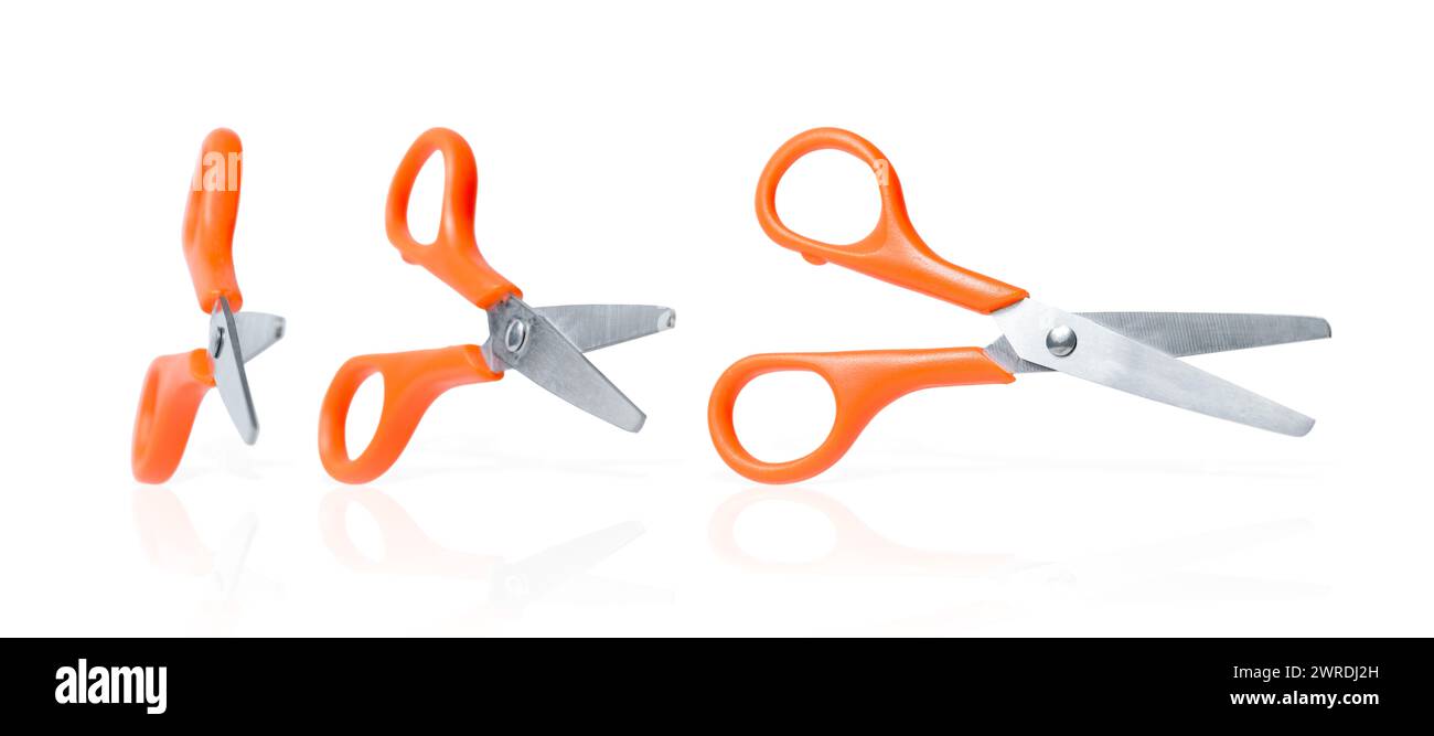 Stationery scissors collection. Three isolated scissors with orange handle on white background. School or office cutters with rings handles. Kids crea Stock Photo