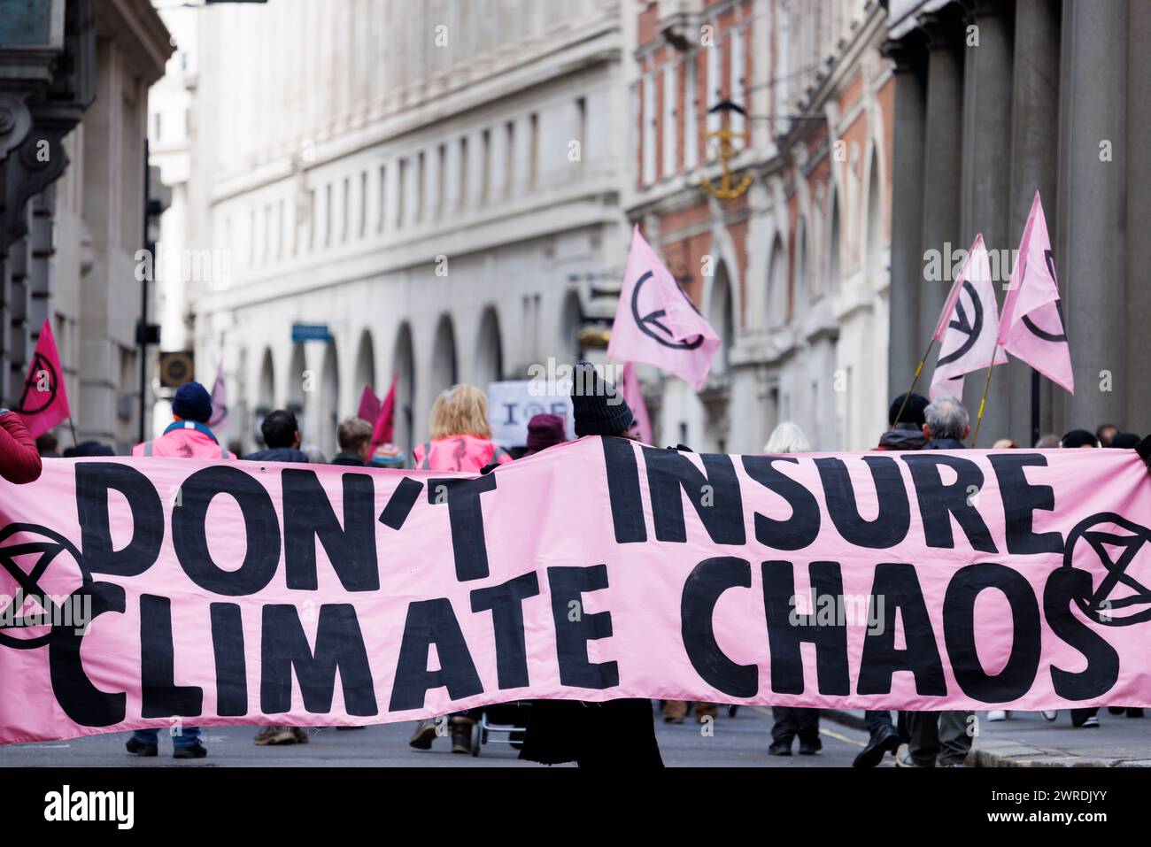 27th Feb. 2024. City of London. 'Insure Our Future' campaigners march in protest at the role of City insurance companies in developing new fossil fuel projects. Stock Photo