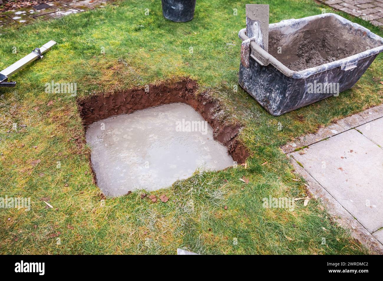 Pouring concrete slab for shed foundation for covering open terrace or patio Stock Photo
