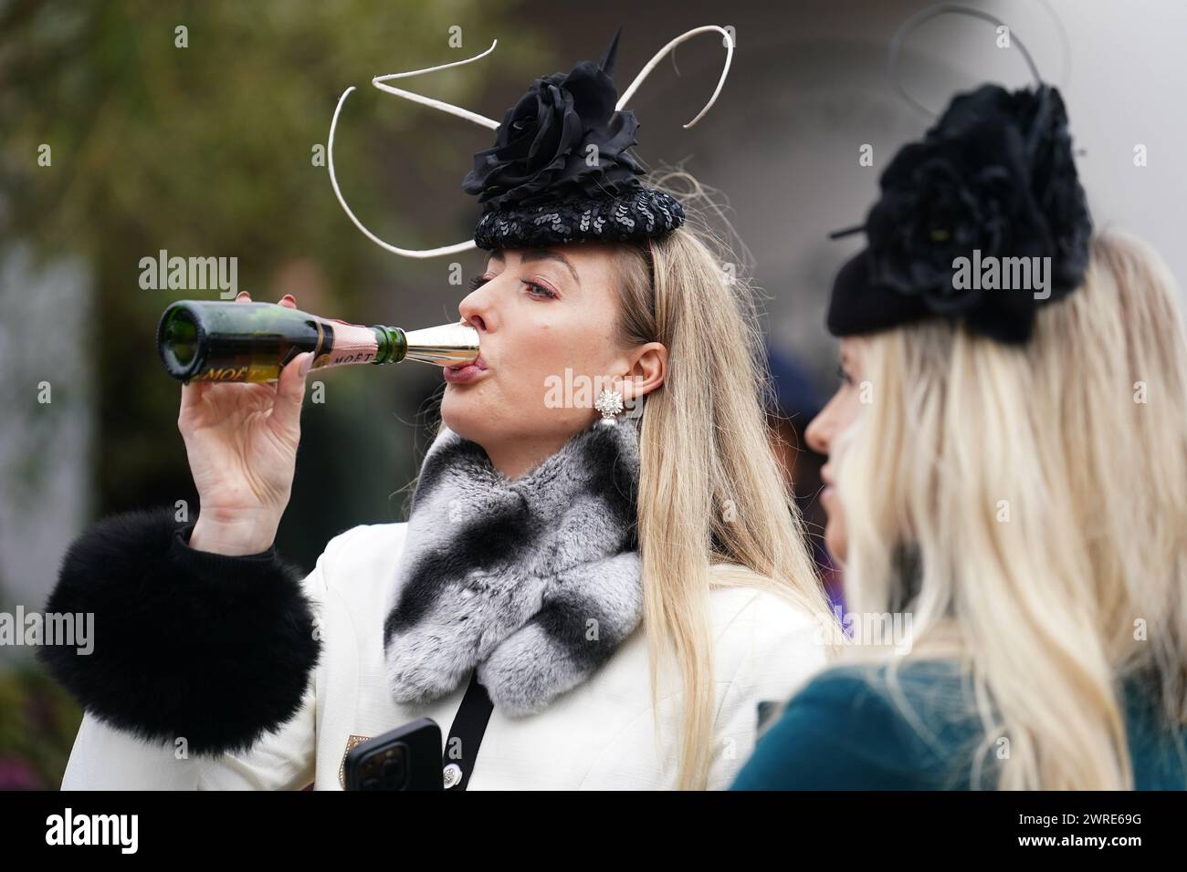Racegoers drinking champagne on day one of the 2024 Cheltenham Festival ...