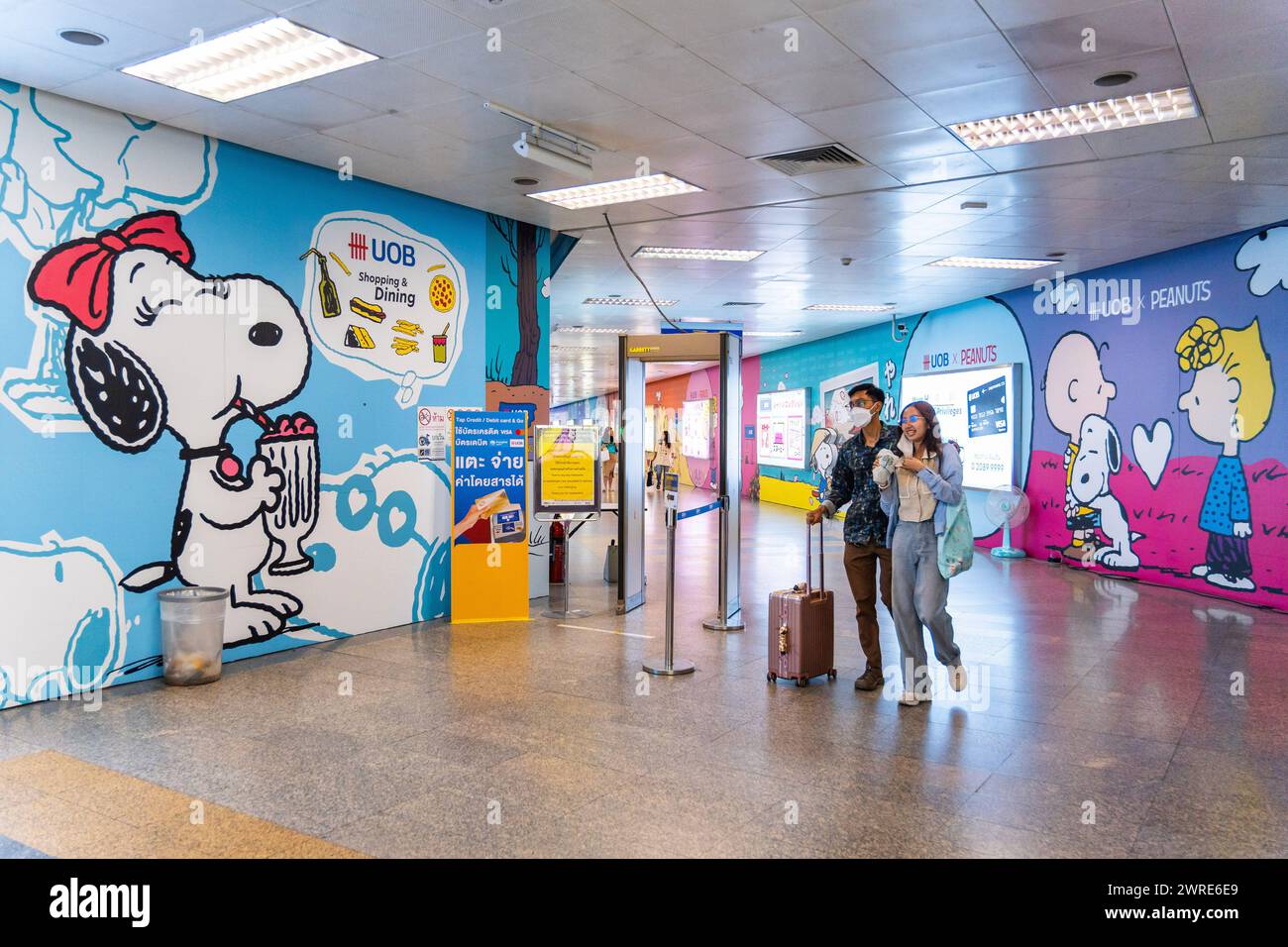 A couple is seen going out of phahon yothin mrt station with the mural