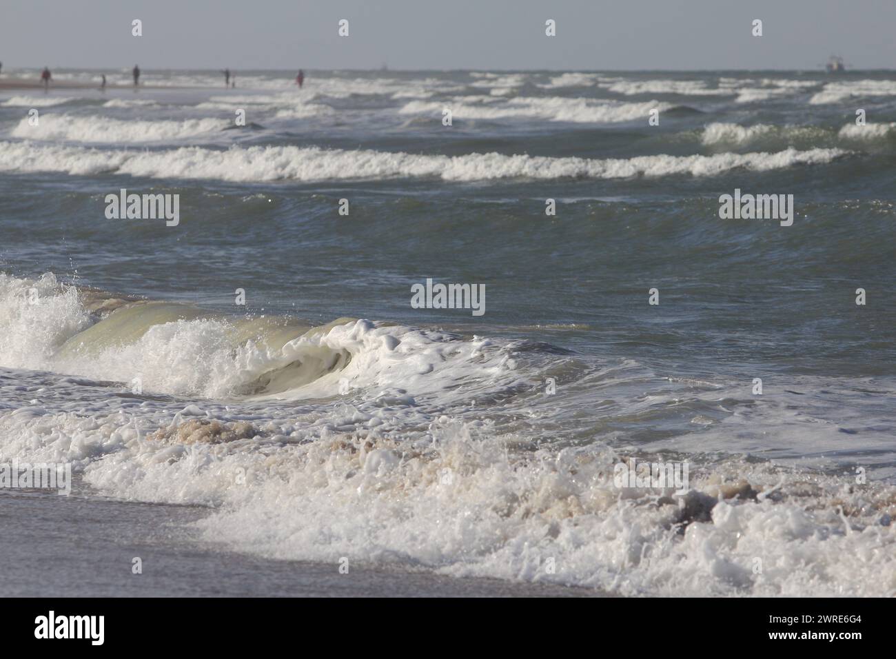 Waves of white foam Crown roll over the sea surface Stock Photo
