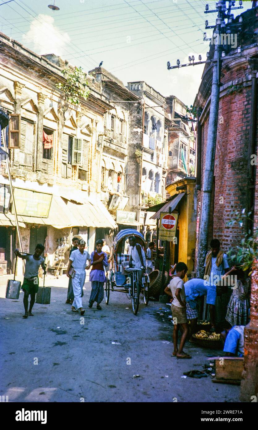 Cycle rickshaw and people on busy city street, Dhaka, Bangladesh, Asia 1962 Stock Photo