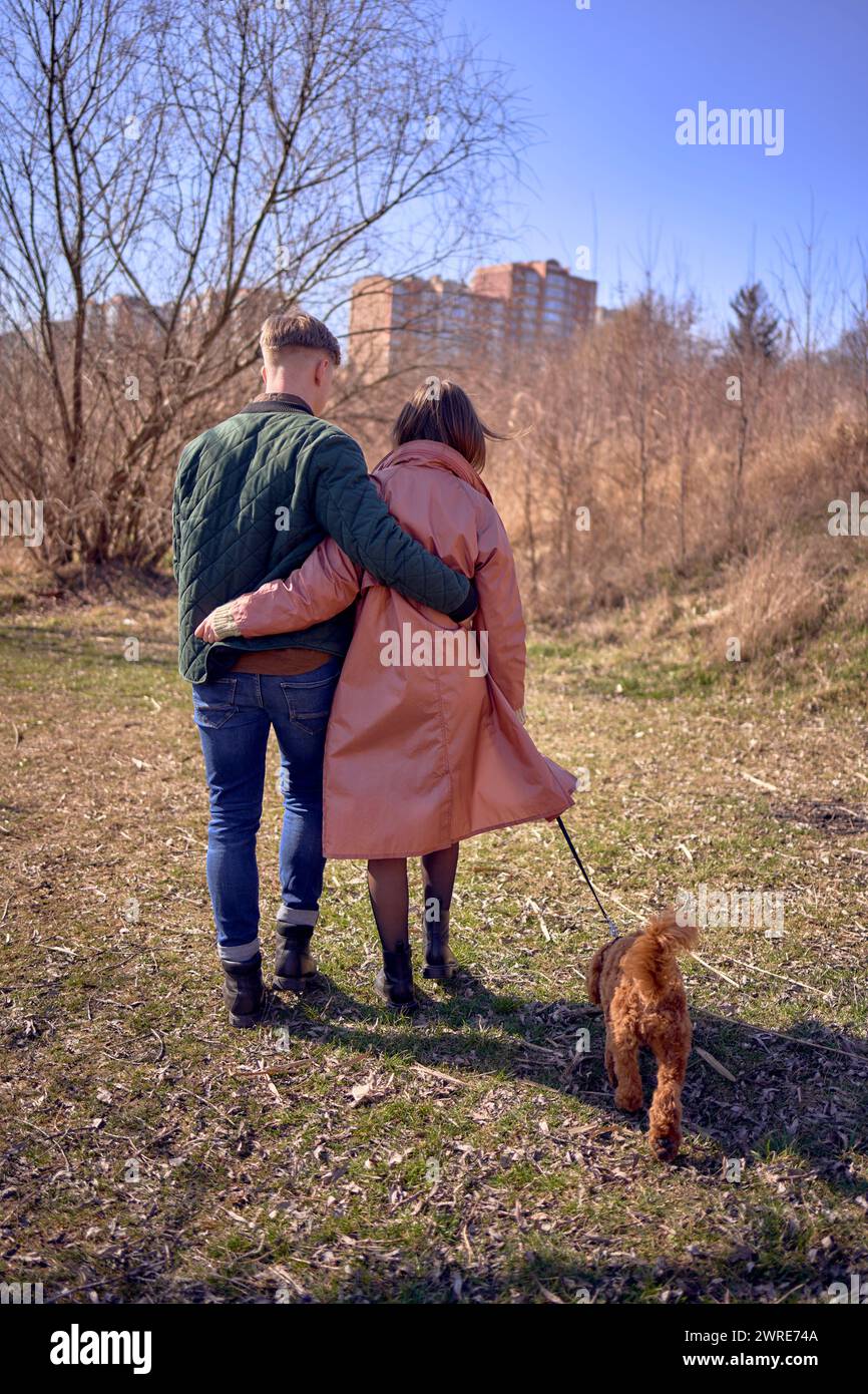 stylish young couple walking with their dog in nature Stock Photo - Alamy