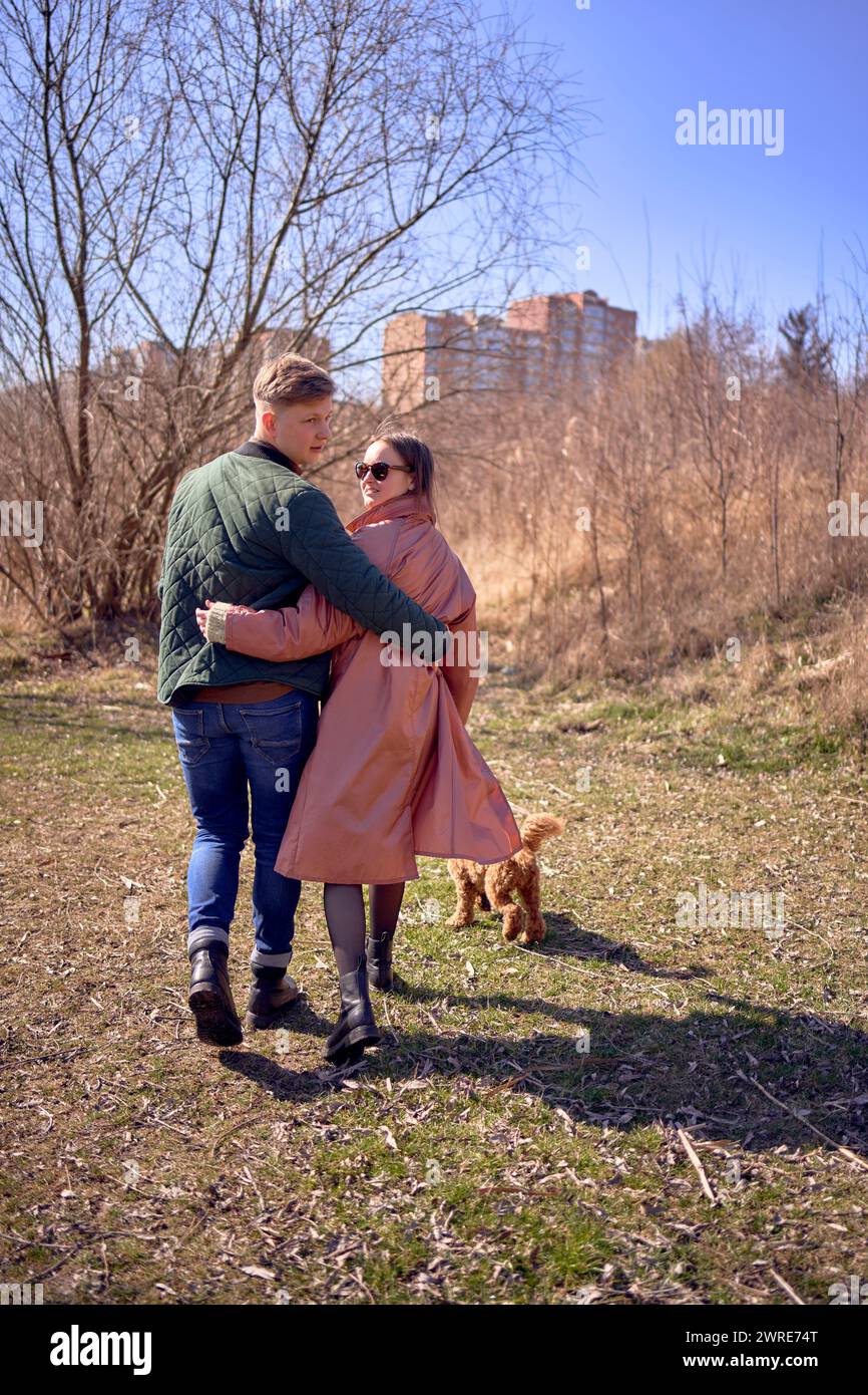stylish young couple walking with their dog in nature Stock Photo - Alamy