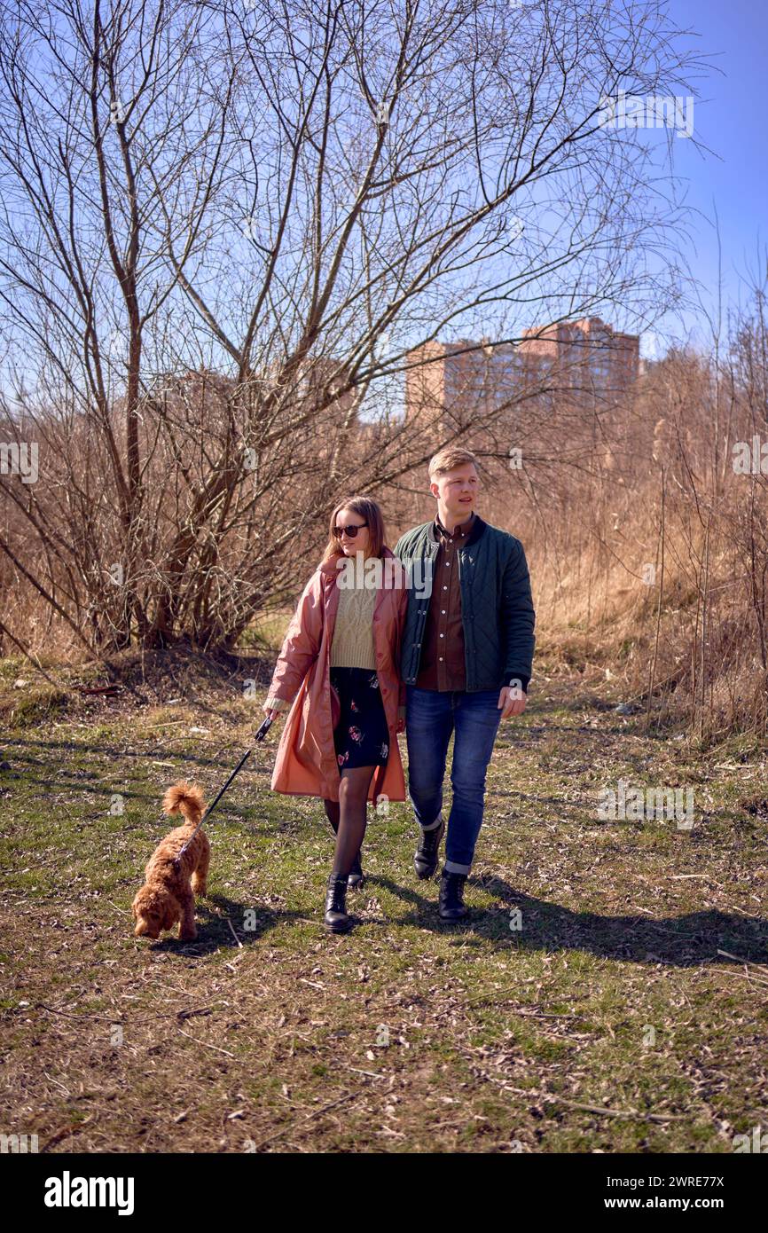 stylish young couple walking with their dog in nature Stock Photo - Alamy