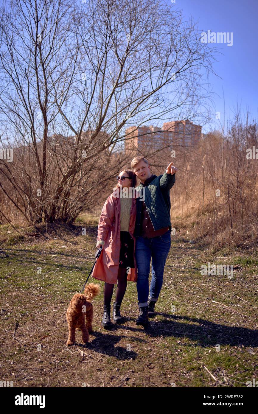 stylish young couple walking with their dog in nature Stock Photo - Alamy