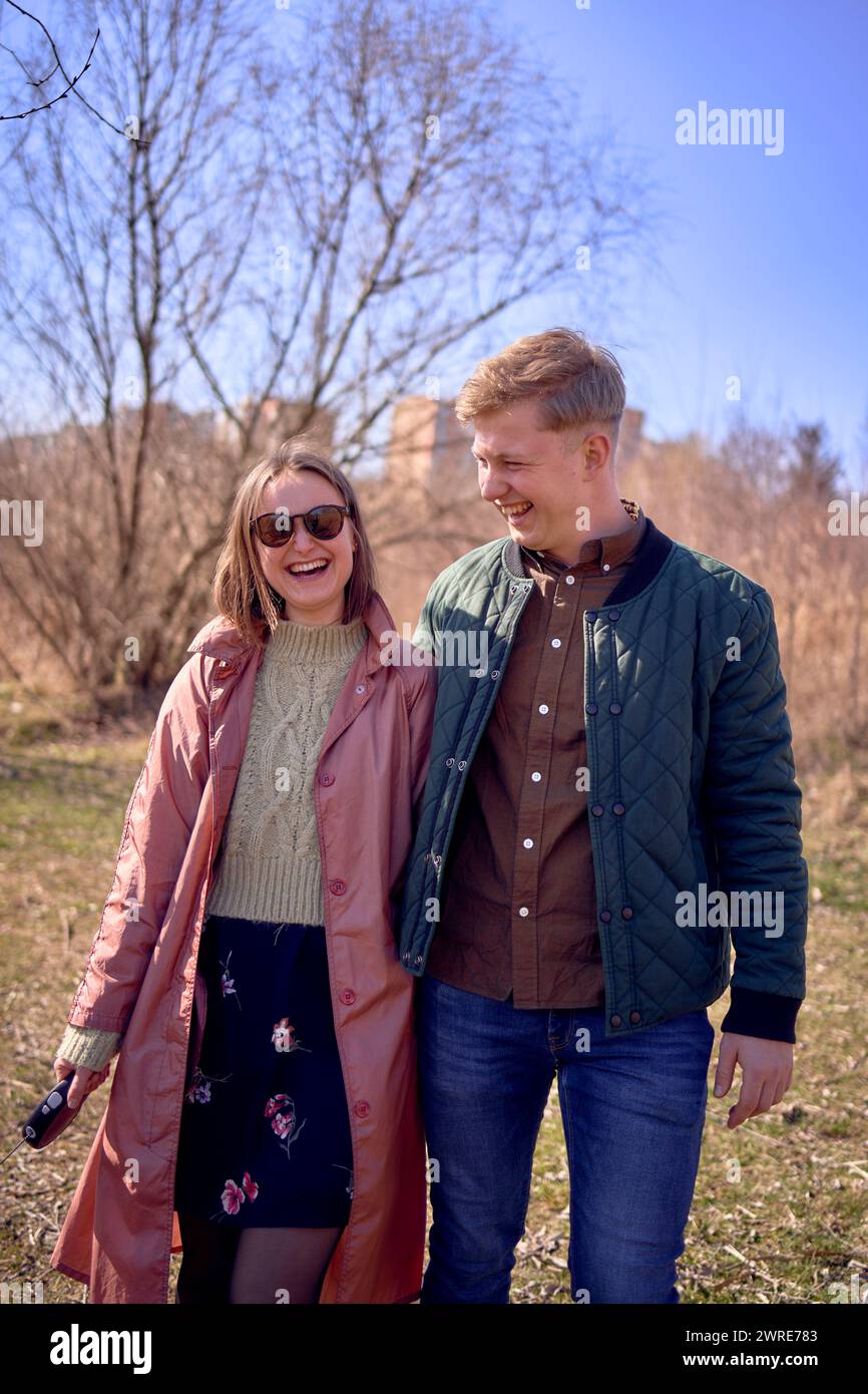 stylish young couple walking with their dog in nature Stock Photo - Alamy