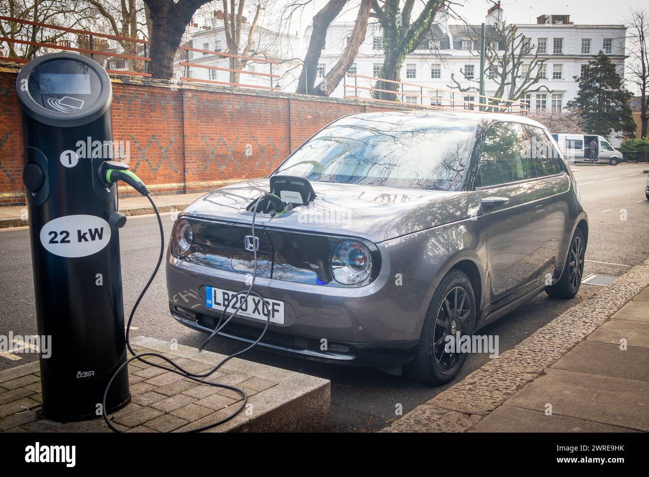 LONDON- JANUARY 11 , 2024: Honda E electric car charging on roadside in South Kensington Stock Photo