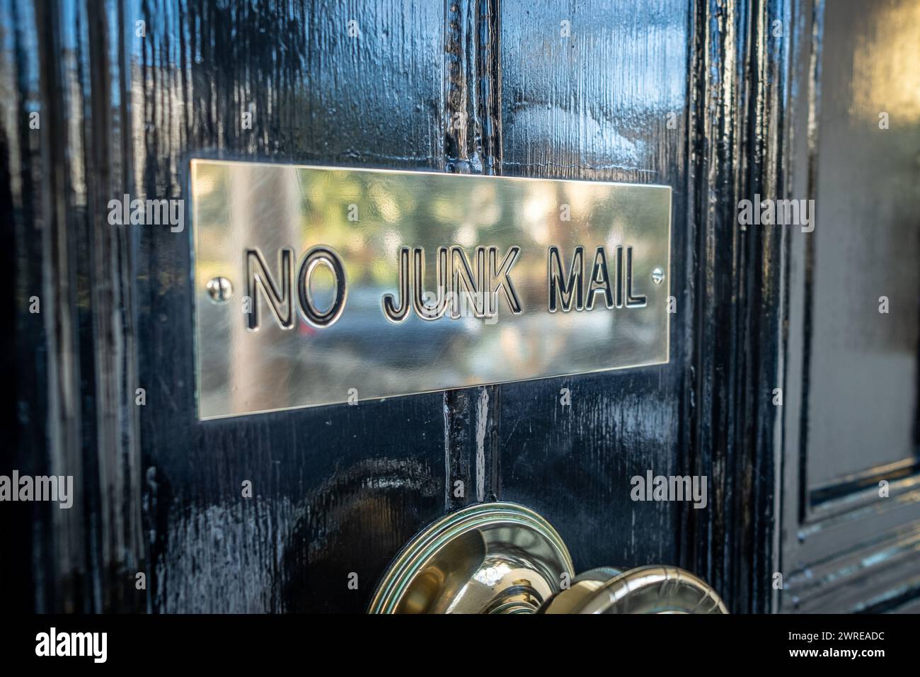 No Junk Mail sign on black British residential door. Stock Photo