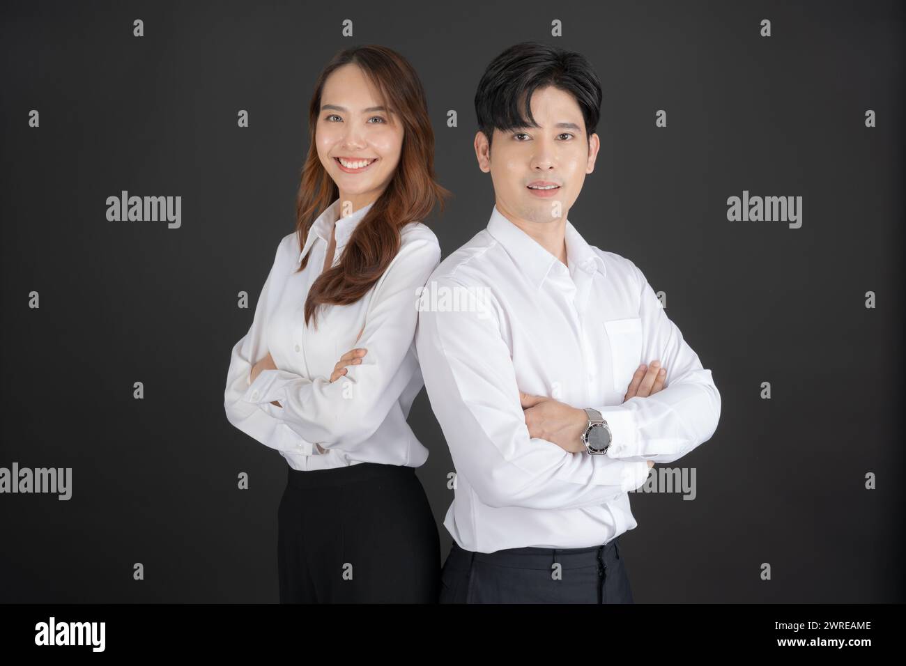Two young businessmen standing with their arms crossed Show ...