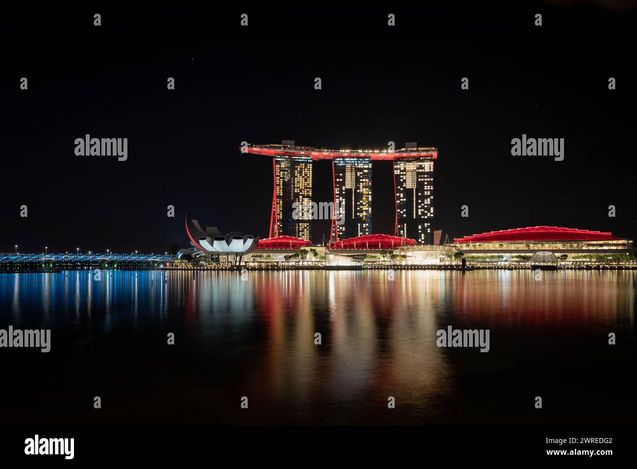Cityscape with illuminated buildings reflecting on water Stock Photo ...