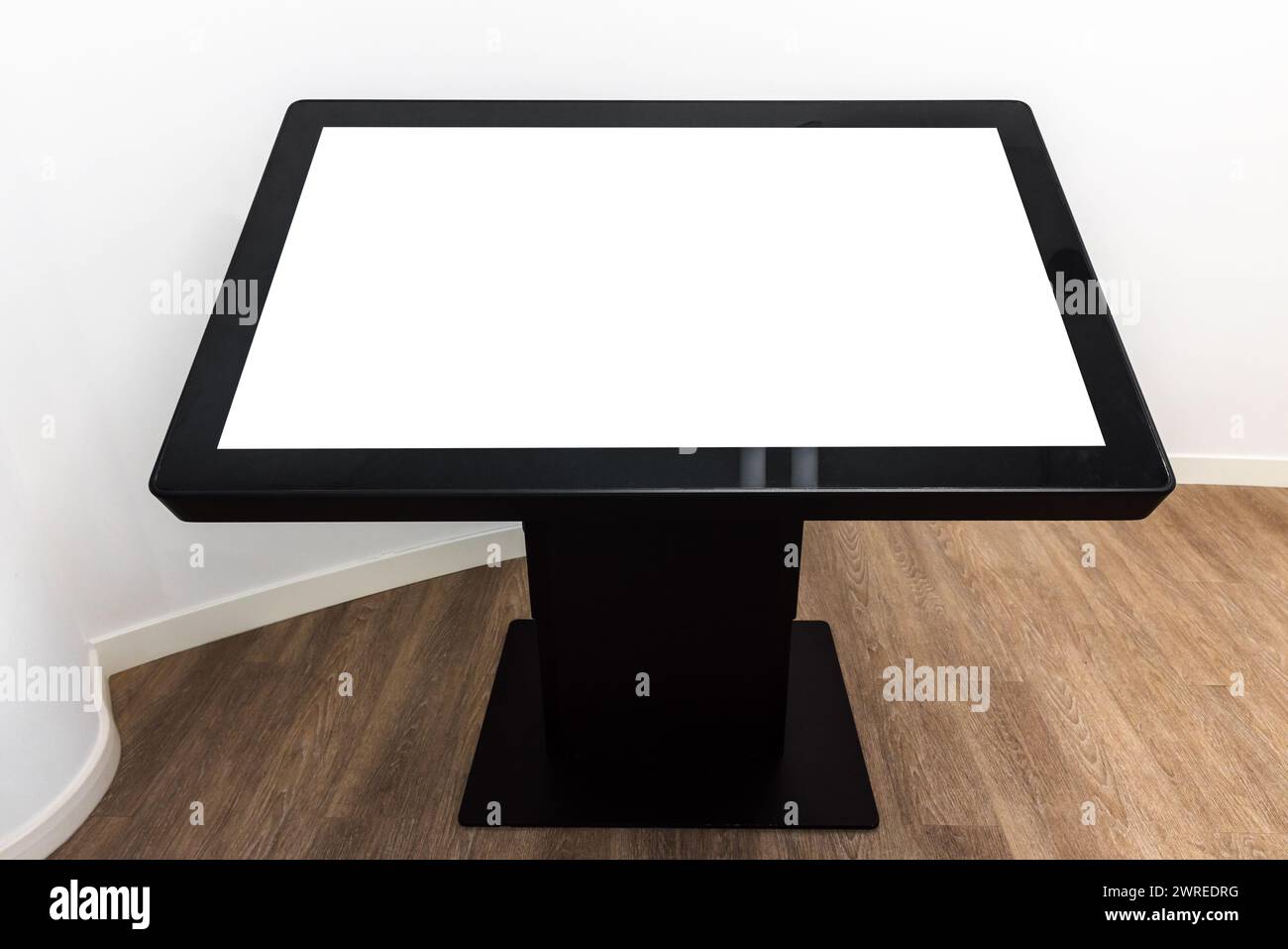 Black interactive touch table with empty blank screen stands in white ...