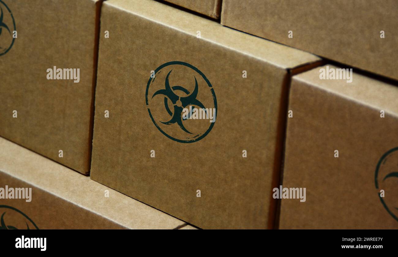 Biohazard warning stamp printed on cardboard box. Biological hazard symbol concept. Stock Photo