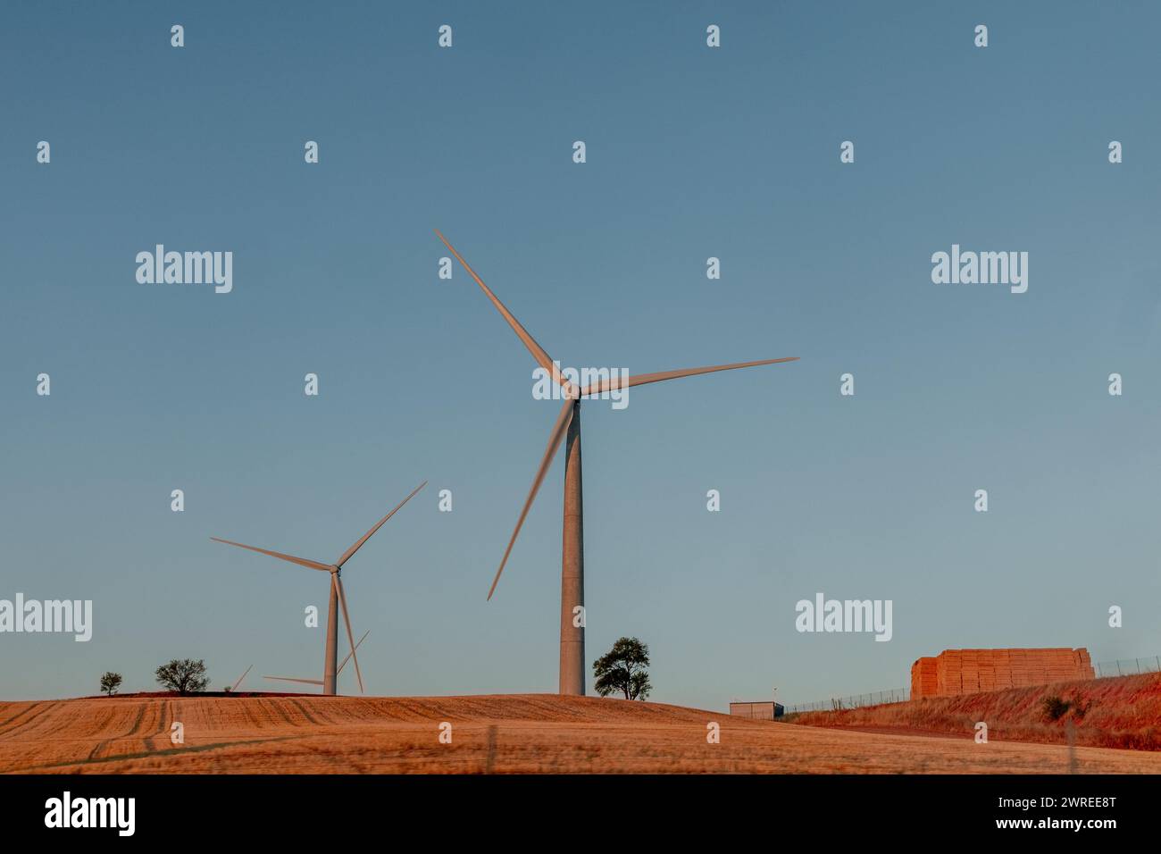 Three wind turbines adorn the hilltop, harnessing wind energy in the ecoregion Stock Photo
