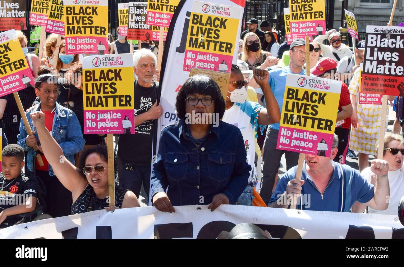 London, United Kingdom. 17th July 2021. Labour MP Diane Abbott stands with demonstrators taking the knee and holding Black Lives Matter placards. Protesters held speeches and took the knee outside Downing Street in solidarity with England football players Marcus Rashford, Bukayo Saka and Jadon Sancho following the online racist abuse the trio received after the Euro 2020 final between England and Italy. (Credit: Vuk Valcic / Alamy) Stock Photo