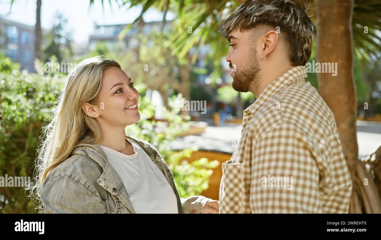 Smiling woman and man lovingly engage in conversation amidst lush green ...
