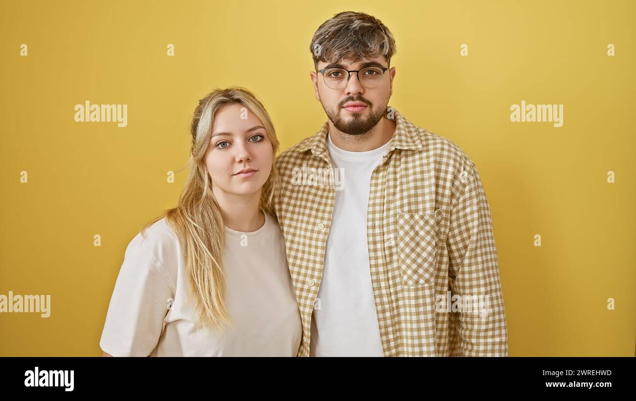 A young man and woman stand close together, expressing unity against a ...