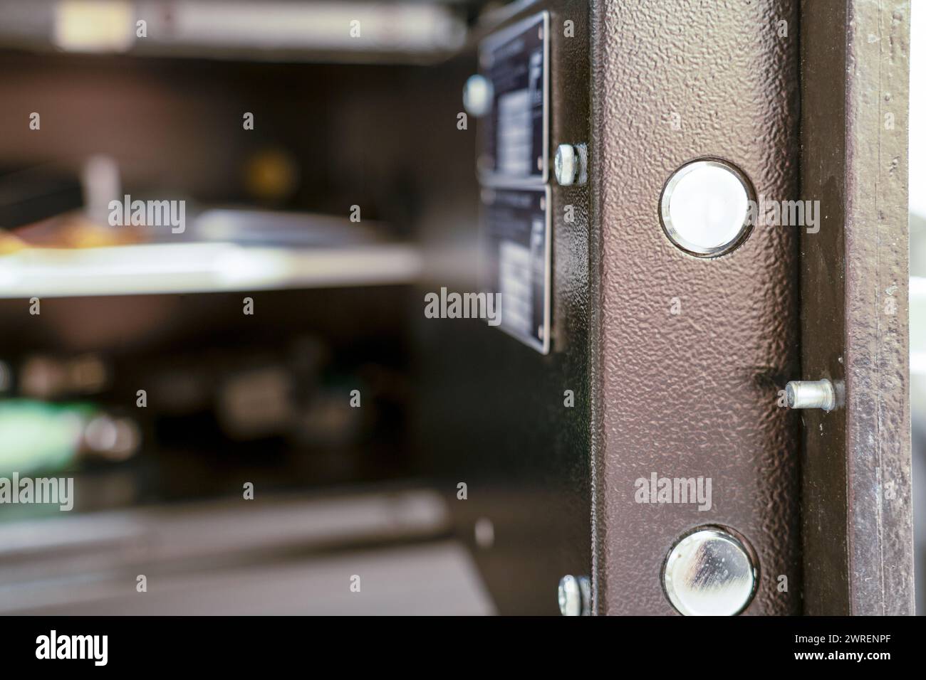 Black office safe with open door, showing the locking bars and blurry content. Stock Photo