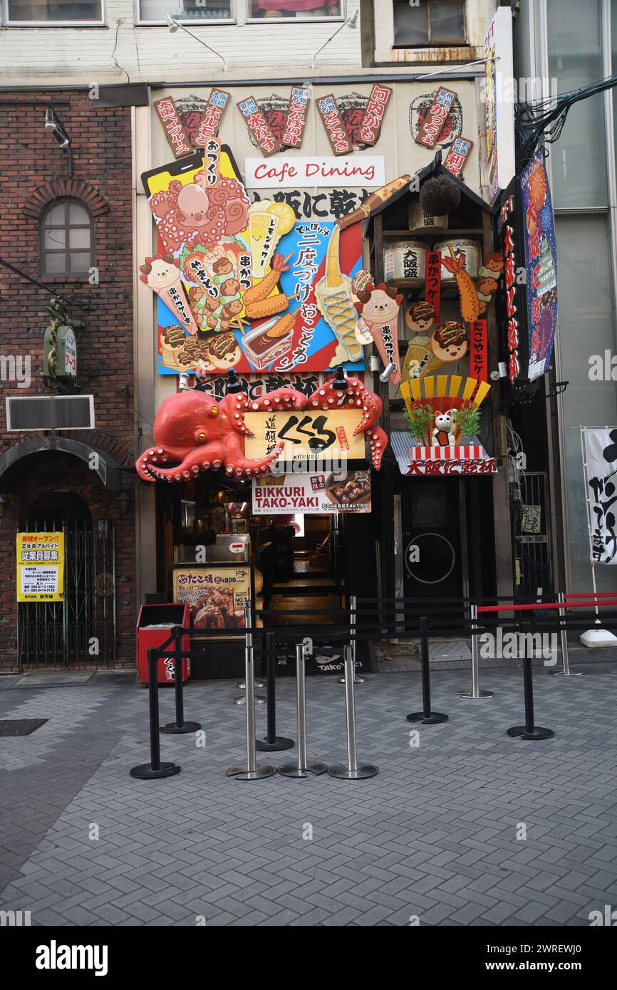 The entrance of a shop selling takoyaki, a ball-shaped Japanese snack made of a wheat flour-based batter in a shop in Dotonbori area in Osaka, Japan Stock Photo