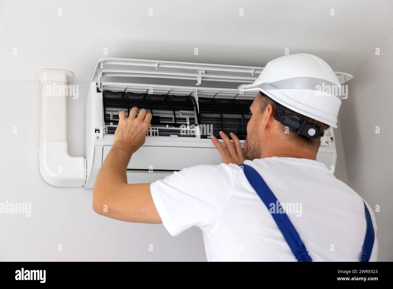 air conditioner maintenance and repair. hvac service technician at work Stock Photo