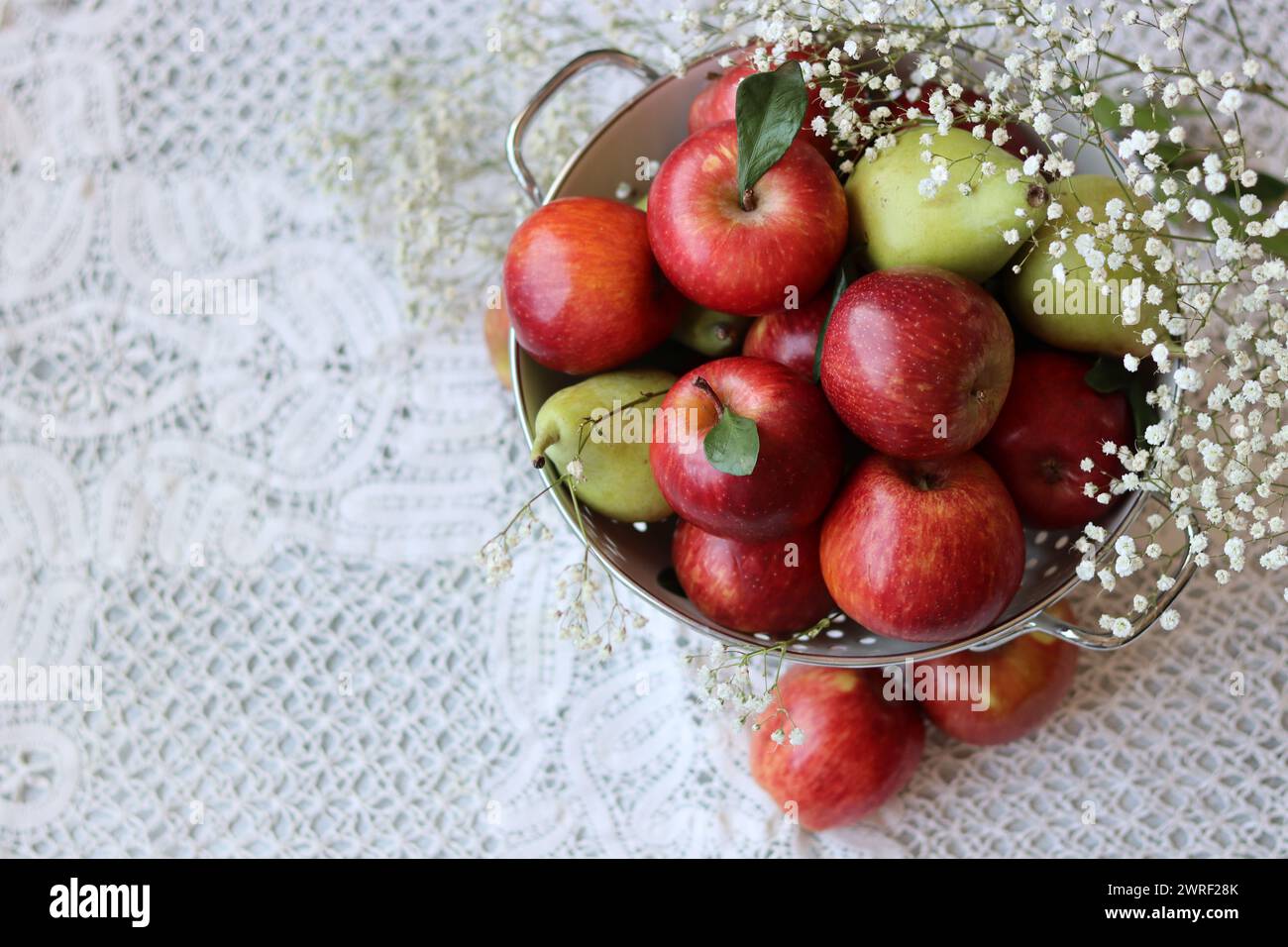 Shiny red apples in white colander. Close up photo of organic fruit on ...