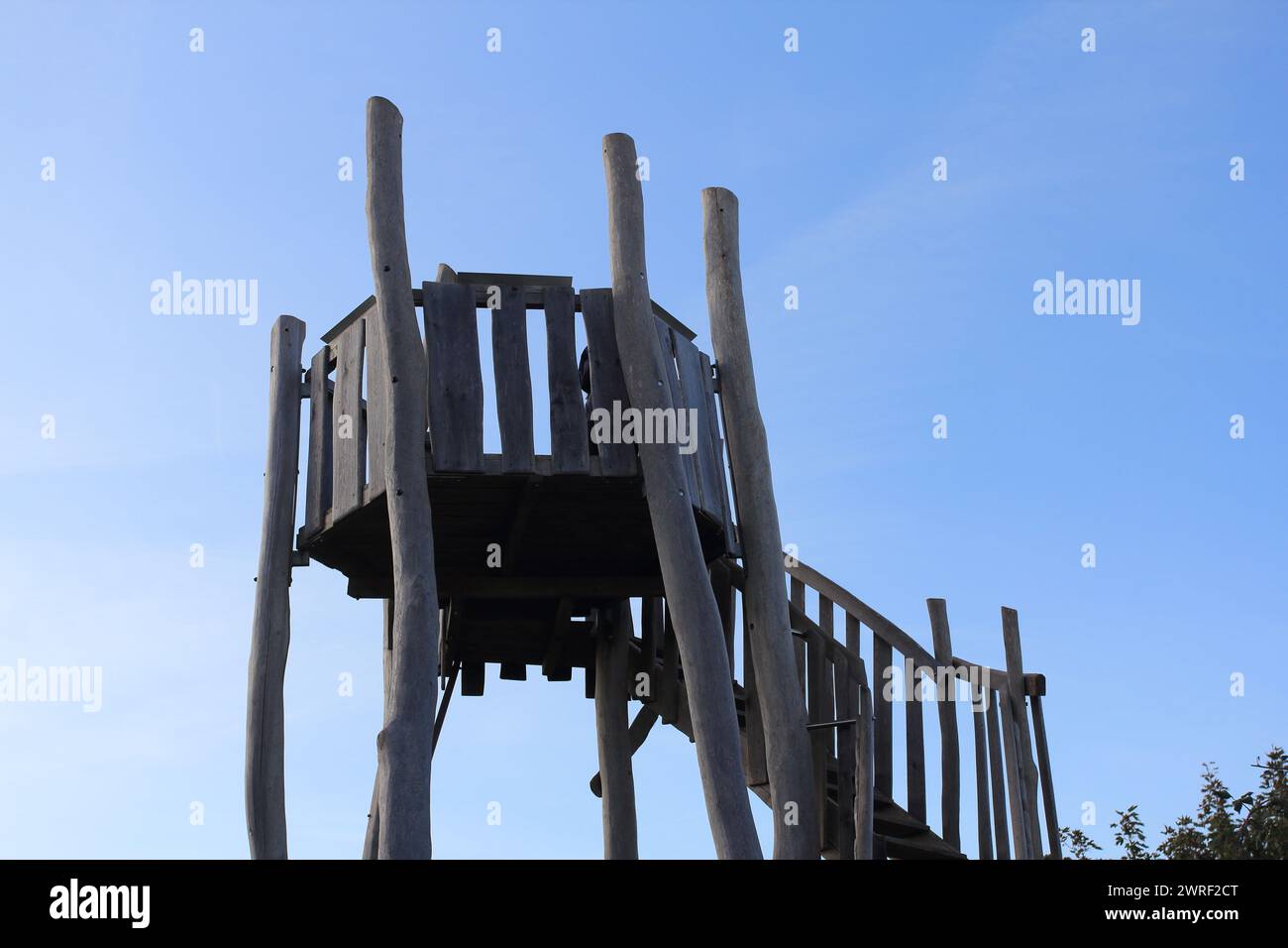 rustic wooden lookout tower, blue sky in the background Stock Photo