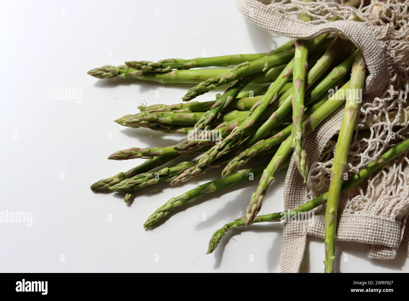 Bunch of fresh green asparagus close up  photo. Raw asparagus top view. Healthy eating concept. Natural vitamins and antioxidants. Stock Photo