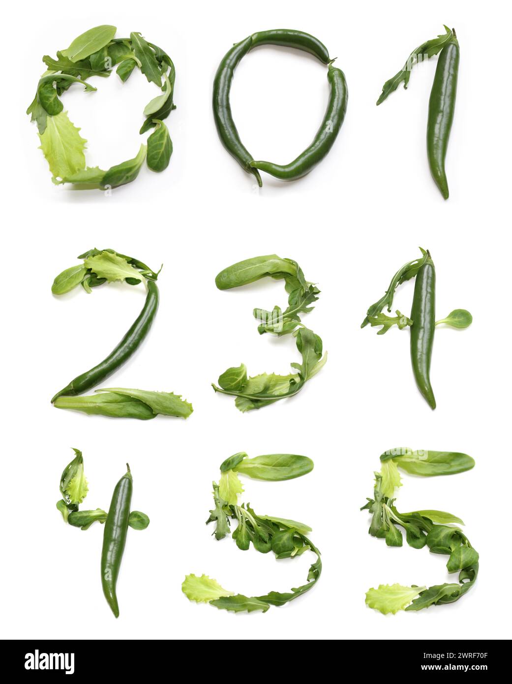 numbers 0 1 2 3 4 5 from green chili pepper, green salad lettuce leaf. vegetarian vegetable number one, two three four five, vegan bowl, birthday meal Stock Photo