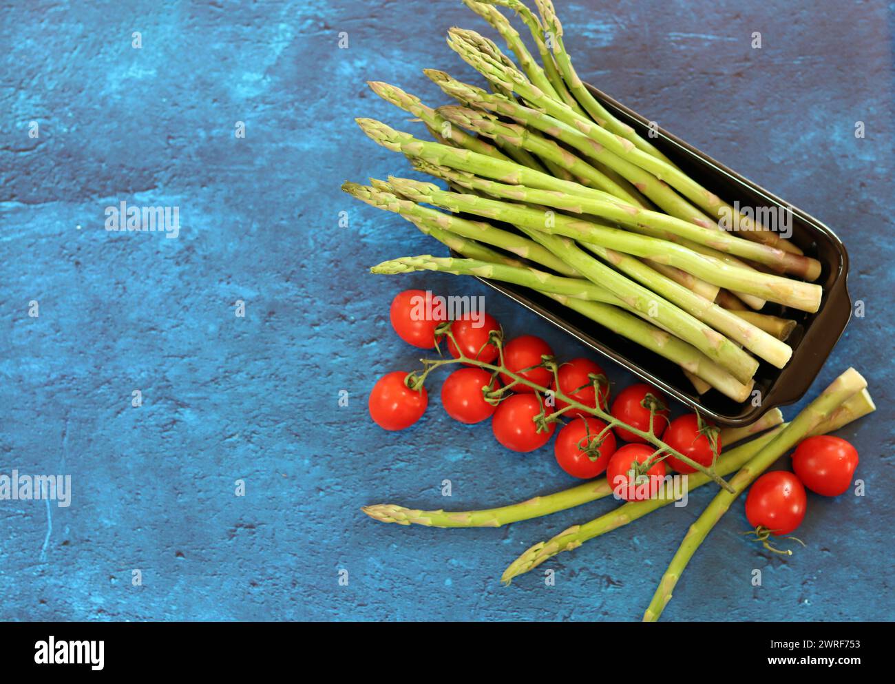 Bunch of fresh green asparagus close up  photo. Raw asparagus top view. Healthy eating concept. Natural vitamins and antioxidants. Stock Photo